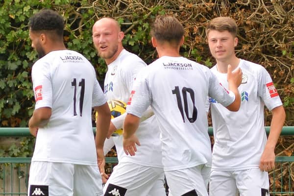 Tommy Scutt, right, is congratulated after one of his two goals at Three Bridges. Picture by Martyn White