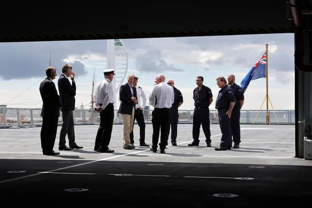Prince Edward pictured with crew of RFA Tidesurge with Portsmouth's Spinnaker Tower in the background. Photo: LPhot Ben Corbett