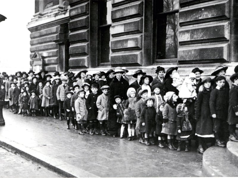 Fatherless children queue at Portsmouth Town Hall for a charity event at the end of the First World War