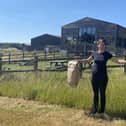 Kayleigh Collett holding local produce and welcoming local suppliers to Westlands Farm Shop