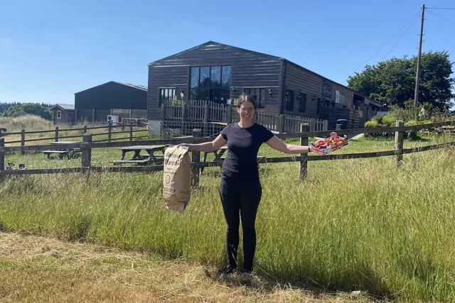 Kayleigh Collett holding local produce and welcoming local suppliers to Westlands Farm Shop