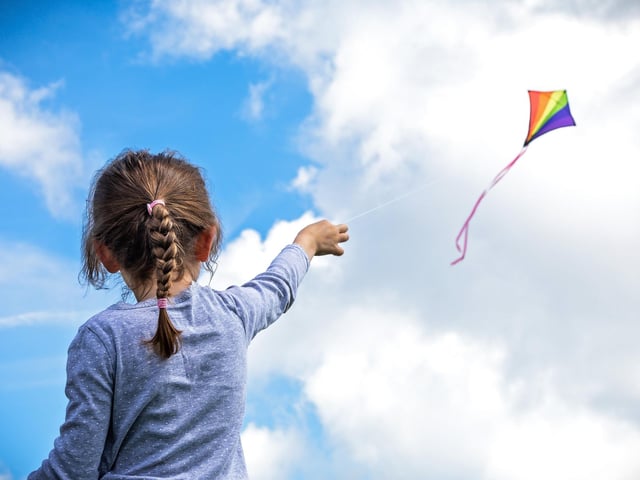Anna Martin (7) making the most of the brisk seafront breeze at the Portsmouth Kite Festival. Picture: Mike Cooter (070821)
