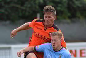 Nathan Kirby (orange), pictured playing for AFC Portchester, has helped Harvest win the Mid-Solent League title.