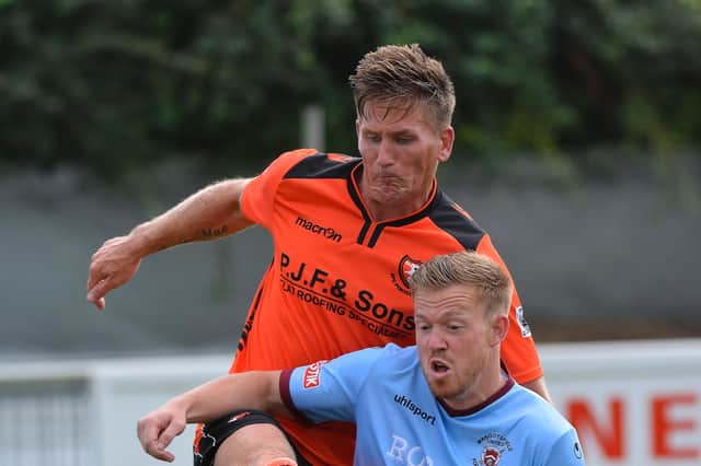 Nathan Kirby (orange), pictured playing for AFC Portchester, has helped Harvest win the Mid-Solent League title.