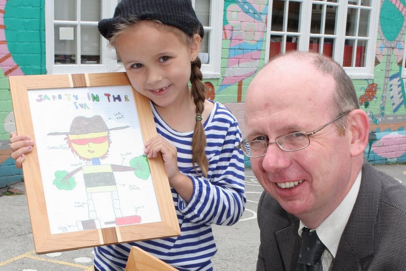 Abercrombie School's Jade White - pupil is pictured with Tim Walker MD of Wildgoose Construction after winning a poster competition.
