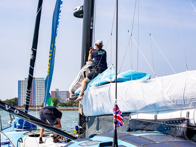 Sailors make last minute preparations before the race begins again.