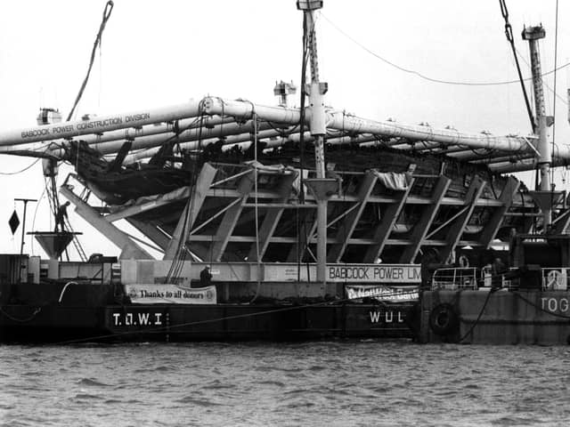 The Mary Rose in her cradle being brought ashore by barge in October 1982.