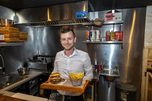 Adam Stevenson, 32, the new manager at the Park Tavern in Spring Street with the speciality PT Burger.. Picture: Mike Cooter (290722)