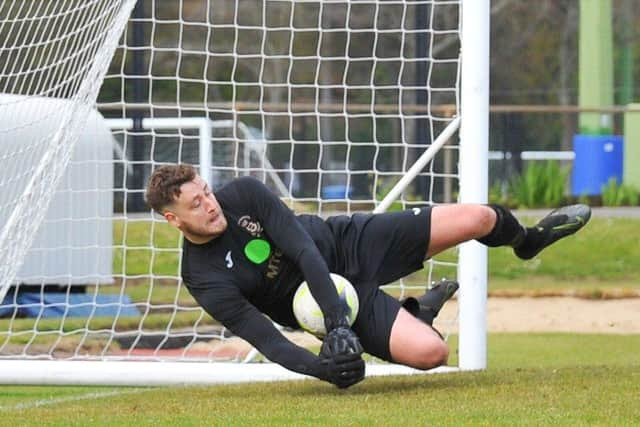 USP keeper Tom Price saves Sean Moore's penalty to give his side the advantage in the shoot-out. Picture: Martyn White.