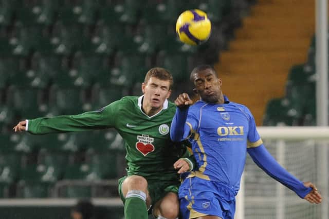 Wolfsburg's Edin Dzeko challenges Sylvain Distin in December 2008. Pompey failed in subsequent attempts to sign him. Picture: AP Photo/Fabian Bimmer
