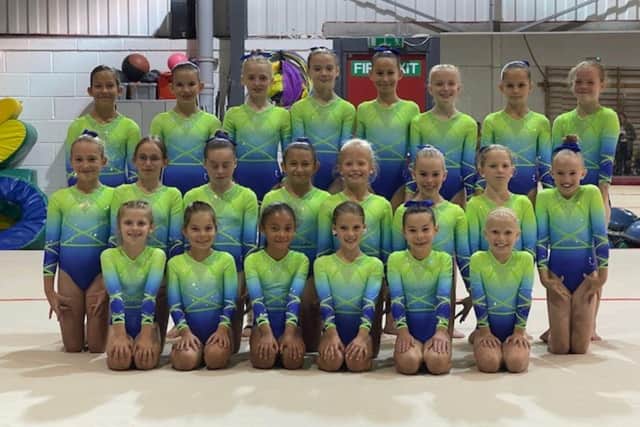 Women's Artistic Squad at Xcel Gymnastics competing in regional tournaments.