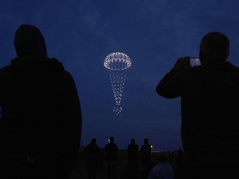 Drones make a parachute during a drone display telling the story of D-Day. Photo: Andrew Matthews/PA Wire