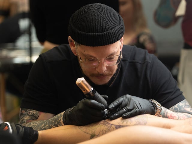 Pictured is: JA Tattoo Artist works on his design.
Picture: Keith Woodland (010421-14)