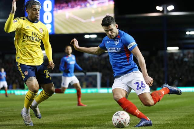 Pompey's Gareth Evans battles with Arsenal's Reiss Nelson. Picture: Joe Pepler