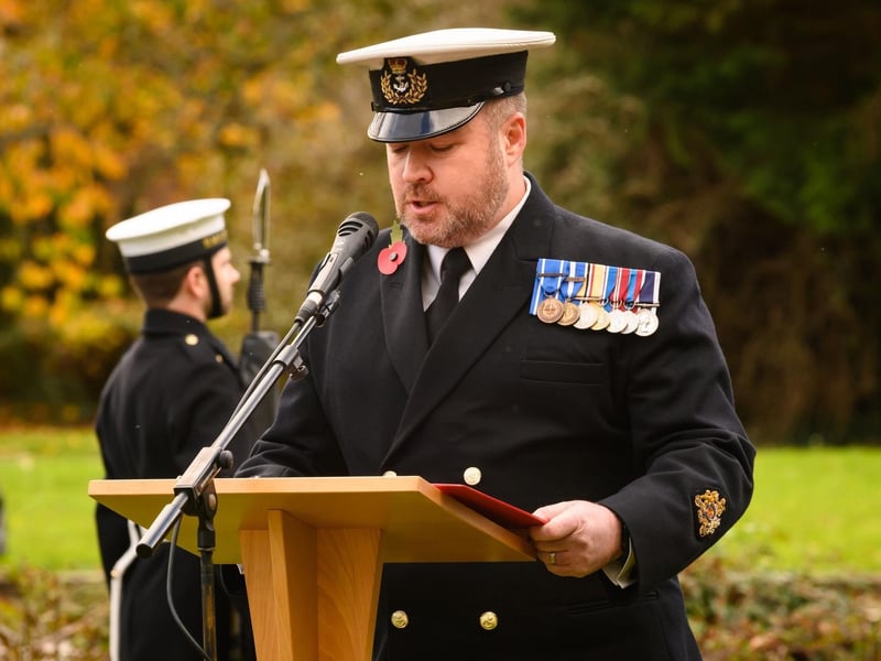WO1 Mark Gower reading the names of the fallen.