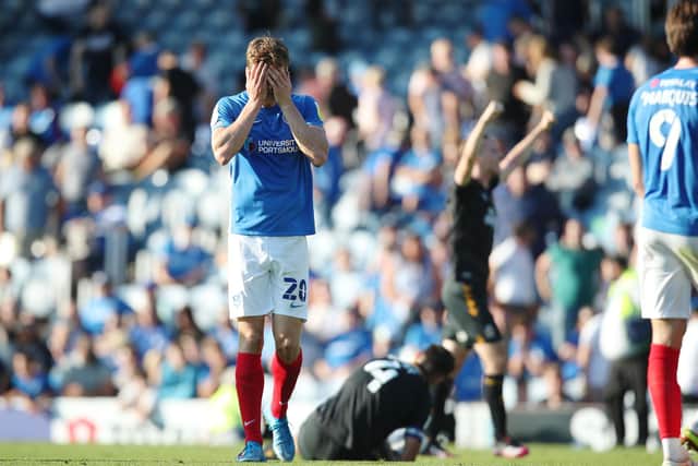 Sean Raggett cuts a dejected figure after Pompey's disappointing 2-1 defeat to Cambridge United on Saturday. Picture: Joe Pepler