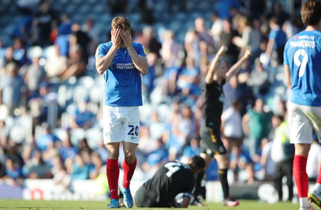 Sean Raggett cuts a dejected figure after Pompey's disappointing 2-1 defeat to Cambridge United on Saturday. Picture: Joe Pepler