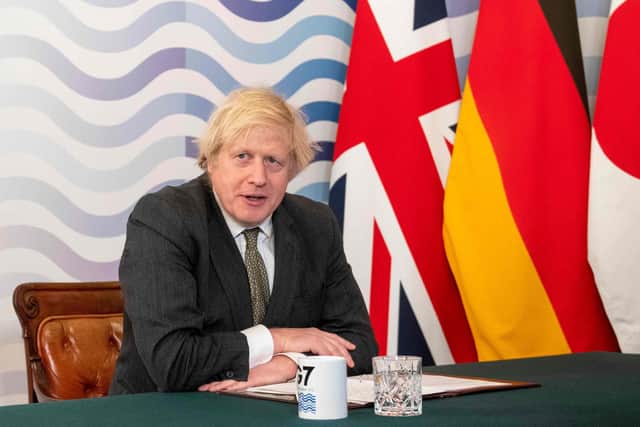 Boris Johnson is expected to give an update on when outdoor team sports can resume in his 'roadmap out of lockdown' announcement on Monday. Photo by GEOFF PUGH/POOL/AFP via Getty Images.