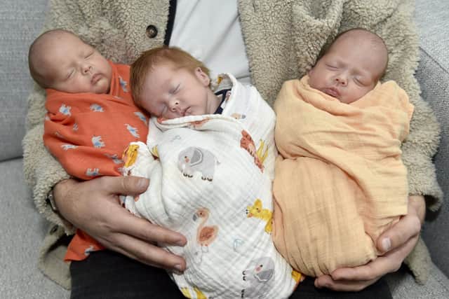 Twin girls Alba and Ava Wise, and in the middle their brother Emil. Picture: Sarah Standing (141223-3674)