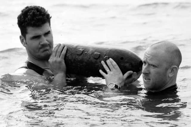 AB Diver Garry Nicholas-Horvarth-Toldi, left, and AB Diver Neil Smith, lift a Second World War defused bomb out of the Solent, 1995. The News PP5544