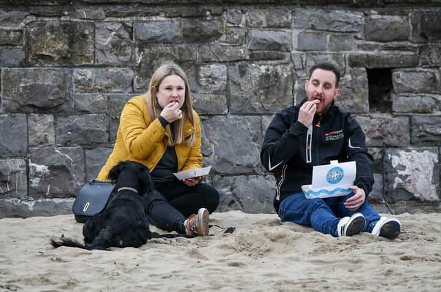 People eat fish and chips. Picture: Ben Birchall/PA Wire