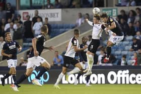 Ronan Curtis heads the ball under pressure from Millwall defender Ryan Leonard in Pompey's Carabao Cup encounter. Picture: Jason Brown/ProSportsImages
