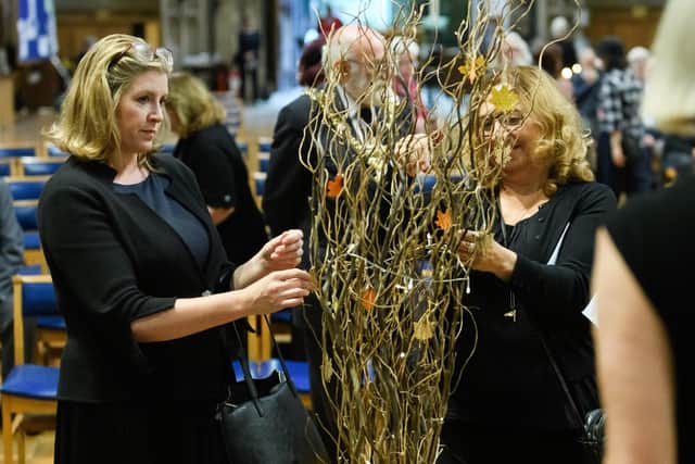 Penny Mourdan, MP for Portsmouth North, attaches a leaf to a tree with a message of sympathy to the Royal Family.
Picture: Keith Woodland (170921-50)