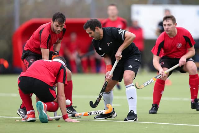Niall Stott is surrounded by the red shirts of Plymouth Marjon. Picture: Chris Moorhouse