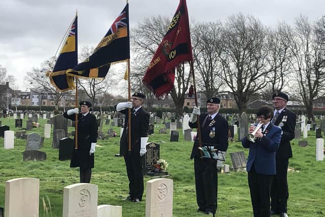 Standard being raised after The Last Post. Photo: Tom Cotterill