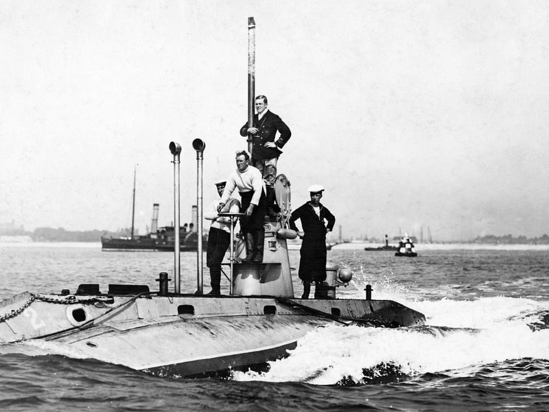 Officers and crew stand on deck around the conning tower of the second Royal Navy Holland-class submarine HMS Holland 2 on patrol entering Fort Blockhouse submarine base near Gosport circa 1905 off Gosport, United Kingdom.  (Photo by Paul Thompson/FPG/Getty Images)