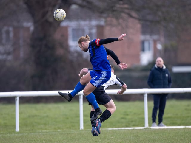 Clanfield's Jake Knight rises highest for a header. Photo by Alex Shute