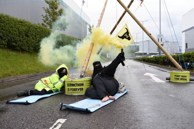 Animal Rebellion protesters attached to a bamboo structure and releasing a yellow smoke canister, outside a McDonalds distribution site in Basingstoke. Picture: Andrea Domeniconi/PA Wire



NOTE TO EDITORS: This handout photo may only be used in for editorial reporting purposes for the contemporaneous illustration of events, things or the people in the image or facts mentioned in the caption. Reuse of the picture may require further permission from the copyright holder.
