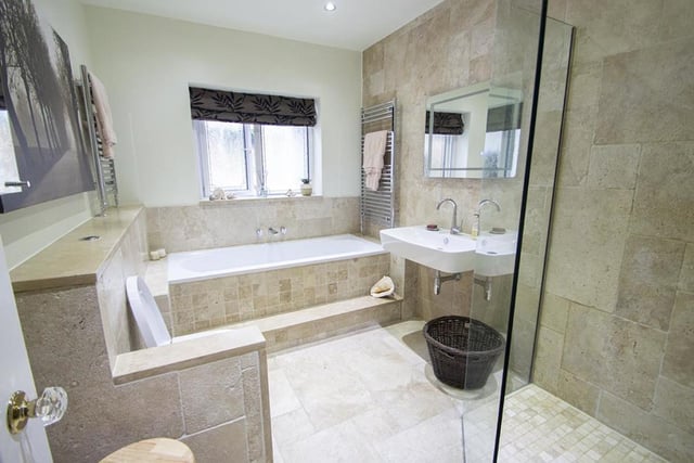 The spacious family bathroom looks out to the garden and boast underfloor heating.