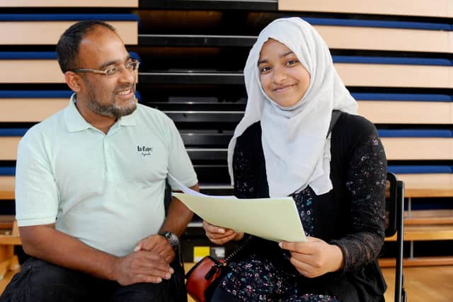 Anisa Rahman-Choudhury (16) who got eight 9s and 2 A*s, with her dad Tipu Rahman (47). Picture: Sarah Standing (200820-2944)