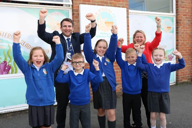 New Horizons Primary School has been rated good in recent Ofsted inspection. 
Pictured: Head of School, Mr Jones, and students.