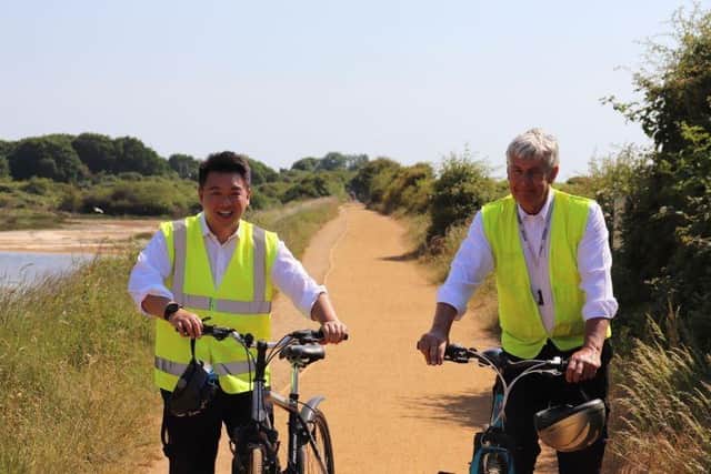 Alan Mak MP cycles on the Hayling Billy Trail with Hayling County Councillor Lance Quantrill