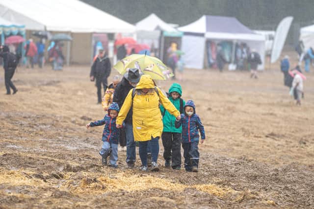 A family wade through the drenched mud at Wickham Festival
Picture: Andy Hornby