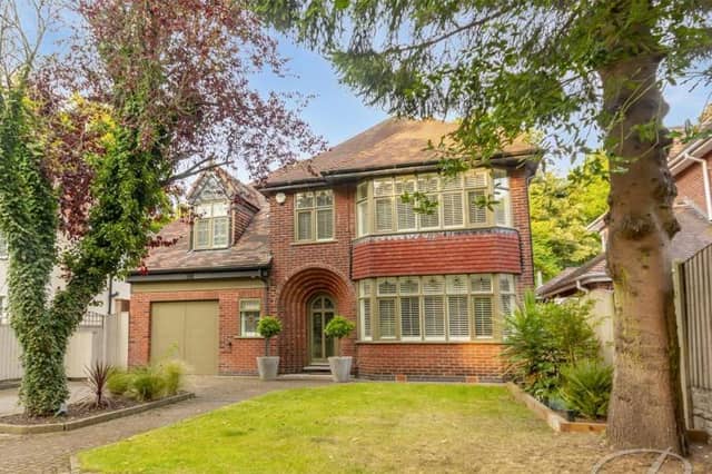 Nestled behind trees, the impressive facade of the Nottingham Road property. A spacious driveway offers ample off-street parking, while the lawn is low maintenance.