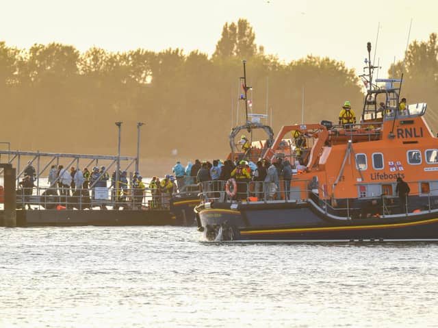 Around 140 migrants arrive in Portsmouth, Hampshire after being transferred from a single dingy south of the Isle of Wight in the English Channel by two RNLI lifeboats, a mammoth operation is talking place on Sunday evening to process the illegal migrants, with dozens of government workers from Police, Border Force, Ambulance and Fire crews, along with a number of transport busses. Viewed from Hayling Island, just across the water.  Dated 06/09/26.