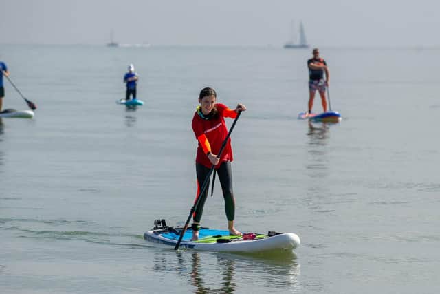 12-year-old Seren Killpartrick from Fareham is paddleboarding from the Isle of Wight to Stokes Bay to raise money for brain tumour treatment for her dad.Pictured: Seren Killpartrick arriving at Stokes Bay beach on Thursday 16th September 2021Picture: Habibur Rahman