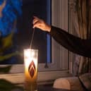Image: Joan Salter MBE, a child survivor of the Holocaust, lighting a candle for Light the Darkness 2024 © Sam Churchill / Holocaust Memorial Day Trust.