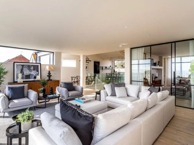 The listing says: "The accommodation, on three floors, is thoughtfully arranged to include two open-plan living and sitting areas, as well as a cosy snug to afford privacy. Three guest bedrooms and bathrooms are placed on the ground floor and have immediate access to the south facing deck and attractively landscaped gardens."