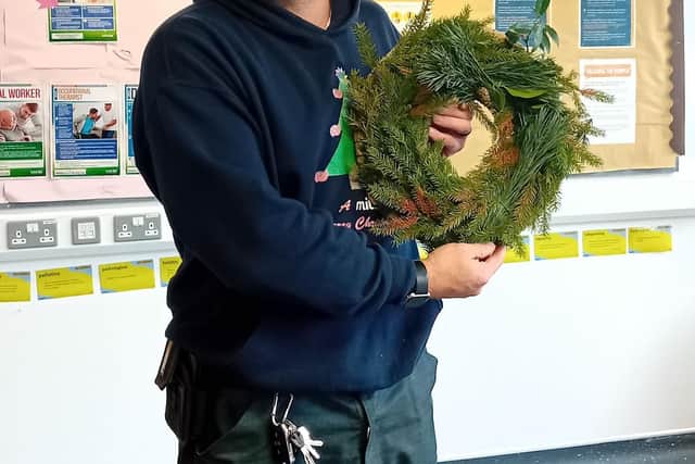 Lee Marsh from Mitie helps Harbour School students create festive Christmas wreaths as part of the Harbour Future Skills programme.