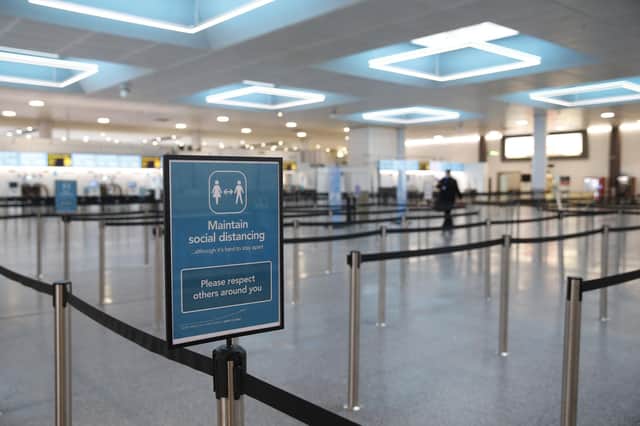 LONDON, ENGLAND - FEBRUARY 06: A social distancing sign inside the North Terminal at Gatwick Airport on February 6, 2021 in London, England. The UK Government has confirmed that anyone travelling to the UK from a country on the UK's travel ban "red list" from 15 February will be required to quarantine in a government-approved facility, such as a hotel room, for 10 days. (Photo by Hollie Adams/Getty Images)