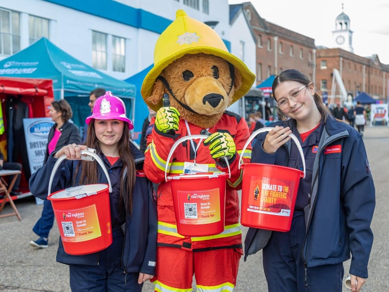 Fire Cadet Shakira Masterman (14) with mascot Blade Bear and Mia Woodhouse (14) From Hampshire and IOW Cadets. Picture: Mike Cooter (280924)