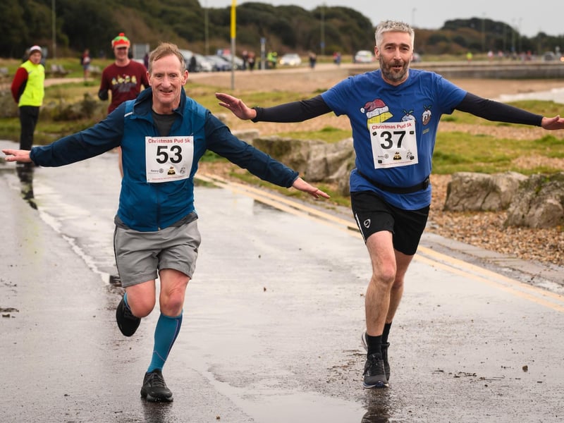 Joe Duffin and Graham Cate cross the line at the Christmas Pud 5k, Stokes Bay, Gosport