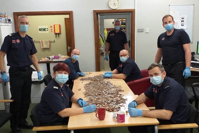 Firefighters in Portchester counting money donated during their Christmas charity drive.