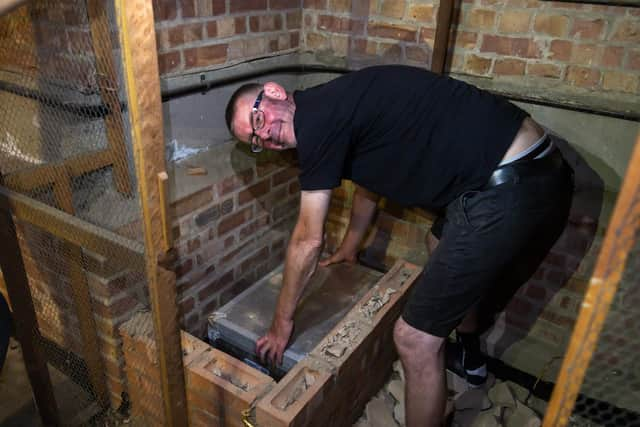 Mark Vernon (48), Site Manager at Bedenham Primary School, places the updated time capsule. Picture: Mike Cooter (120722)