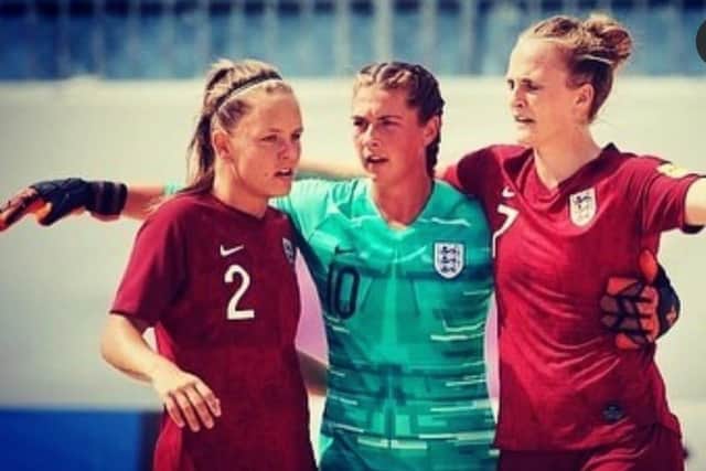 Katie James, left, wearing the Three Lions on international Beach Soccer duty