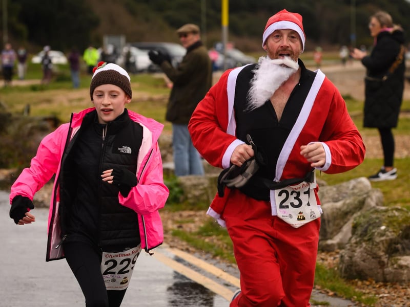 Santa loses his beard as he crosses the Christmas Pud 5k finish line at Stokes Bay, Gosport